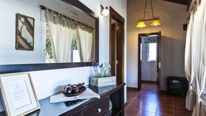 A hotel reception area with a wooden counter, a mirror, a framed menu, and a small plant. - Ideal villa for relaxation, with pool and whirlpool, good views of the mountains (el roque)