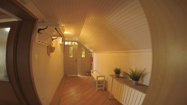 A narrow hallway with wooden flooring, a radiator, and a potted plant on a shelf. - Alpine Style House with Stunning Views, Walking, Biking, Rogla Ski Area+Spa 5km (zrece)