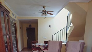 A living room with a sofa, armchairs, a coffee table, and a dining area with a table and chairs. - VILLA ALANDALUS VERA PLAYA (Vera playa)