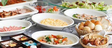 A buffet with various dishes including meats, salads, and pastries.