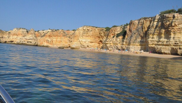 A coastal scene with cliffs and a beach.