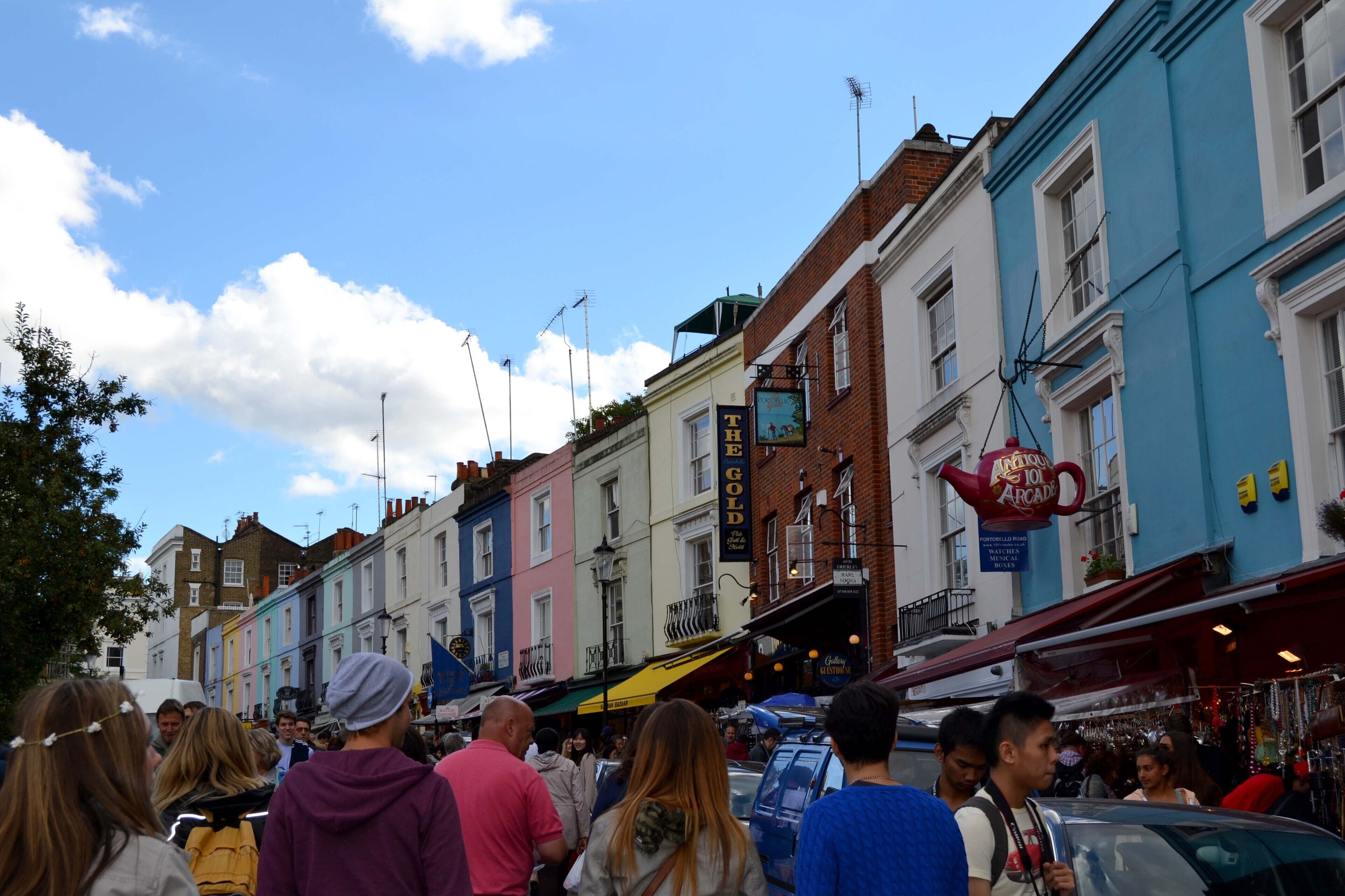 A street with colorful buildings and a crowd of people.