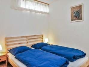 Cozy bedroom with a comfortable bed, nightstand, and a beautiful painting.