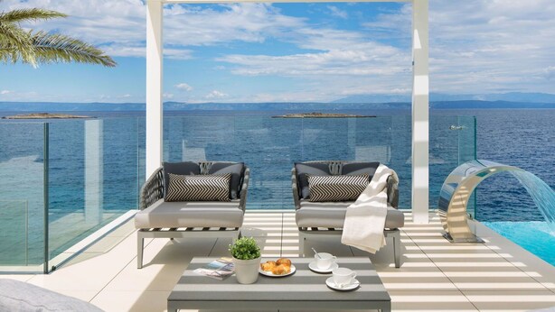 A balcony with two cushioned chairs, a small table with a plant and pastries, and a glass railing overlooking the sea. - Wonderful private villa for 8 guests with private pool, hot tub, WIFI, A/C, TV and terrace (Prigradica)