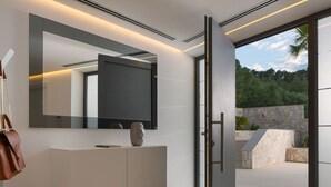 A modern interior with a large mirror, a minimalist vanity, and a sliding glass door leading to an outdoor area. - Wonderful private villa for 8 guests with private pool, hot tub, WIFI, A/C, TV and terrace (Prigradica)