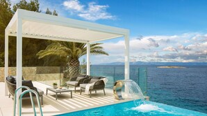 A pool area with a covered seating area, a palm tree, and a view of the sea. - Wonderful private villa for 8 guests with private pool, hot tub, WIFI, A/C, TV and terrace (Prigradica)