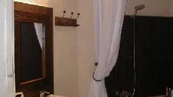Bathtub, hair dryer, towels, toilet paper