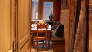 A wooden interior with a dining area, a sofa, and a Christmas tree. - 3 BEDROOMS, COCOONING, CENTER, CHALET STYLE, WELLNESS (Morzine)