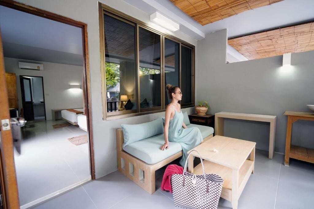 A modern room with a sofa, a small table, and a large window.