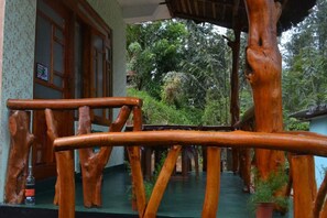 A wooden staircase with a natural, rustic design, surrounded by lush greenery. - Pine Village Home Stay (Ella)