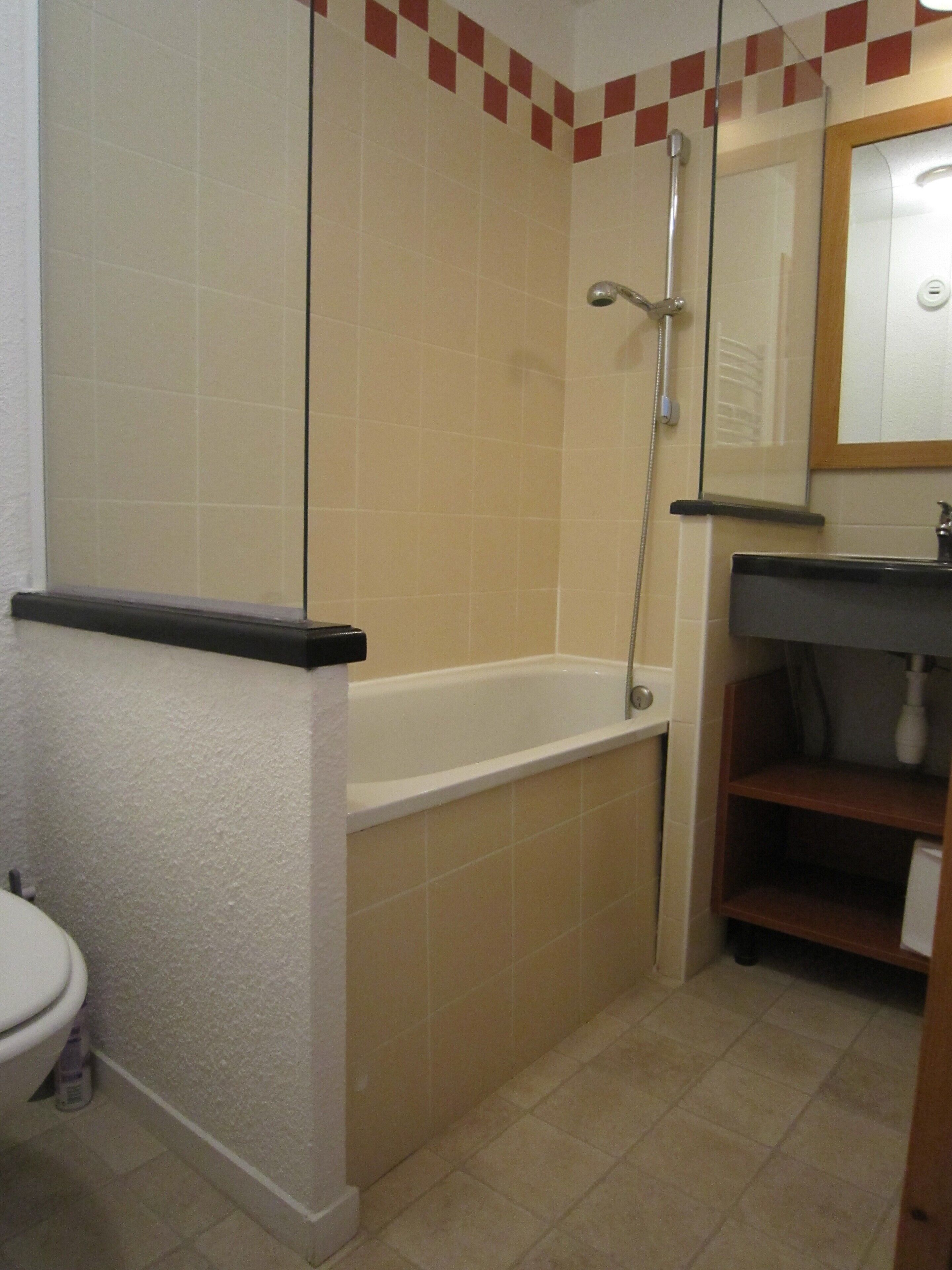 A bathroom with a bathtub, a shower, and a sink.