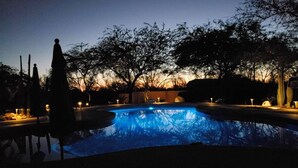 A swimming pool at dusk with surrounding trees and a clear sky. - Cave Creek Guest Suite (Cave Creek)