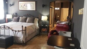 A bedroom with a bed, bedside tables, a desk, and a chair. - Cave Creek Guest Suite (Cave Creek)
