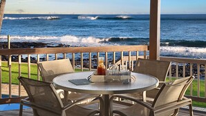 A round table with four chairs on a wooden deck overlooking the ocean. - Honu Lani | Private Oceanfront Home + Pool, Elevated Views & A/C (Koloa)
