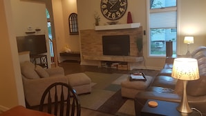 A living room with a fireplace, a television, and a sofa.
