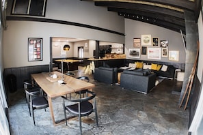 Relax in a stylish lounge area with a pool table, comfortable seating, and artwork on the walls.