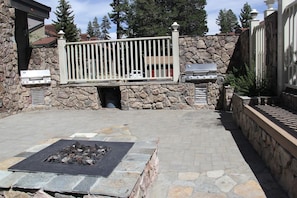 Enjoy al fresco dining and relaxation in this outdoor patio area with barbecue grills and a fire pit.
