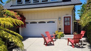 A two-story house with a white garage door, a red door, and a number 226 garage. - Sweet 1 BDRM Cottage, FAST WIFI, near ocean, W&D, Full kitchen and bath, BBQ! (Santa Cruz)