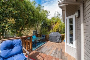 Relax and socialize on this outdoor deck, featuring a barbecue grill and comfortable seating.