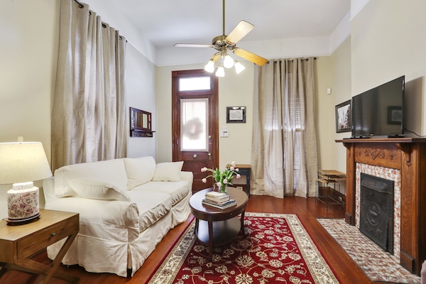 Living room with queen sofa sleeper and large flat screen TV.