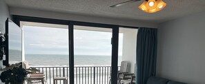 Enjoy ocean views from the balcony with a chair and table.