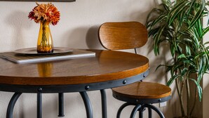 A dining table with a vase of flowers, a framed picture on the wall, and a potted plant. - The Last Best Place With Mountain Views (Bozeman)