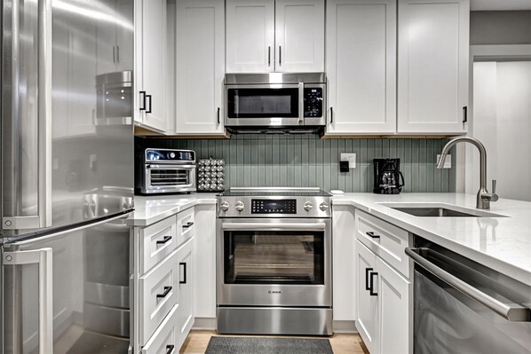 Enjoy cooking in this well-equipped kitchen with an oven, microwave, coffee maker, and dishwasher.
