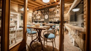 A cozy restaurant with wooden interiors, a central clock, and a brick floor. - a place where stress doesn't exist  (Grižane)