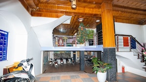 A multi-level building with a checkered floor, a staircase, and a Christmas tree.