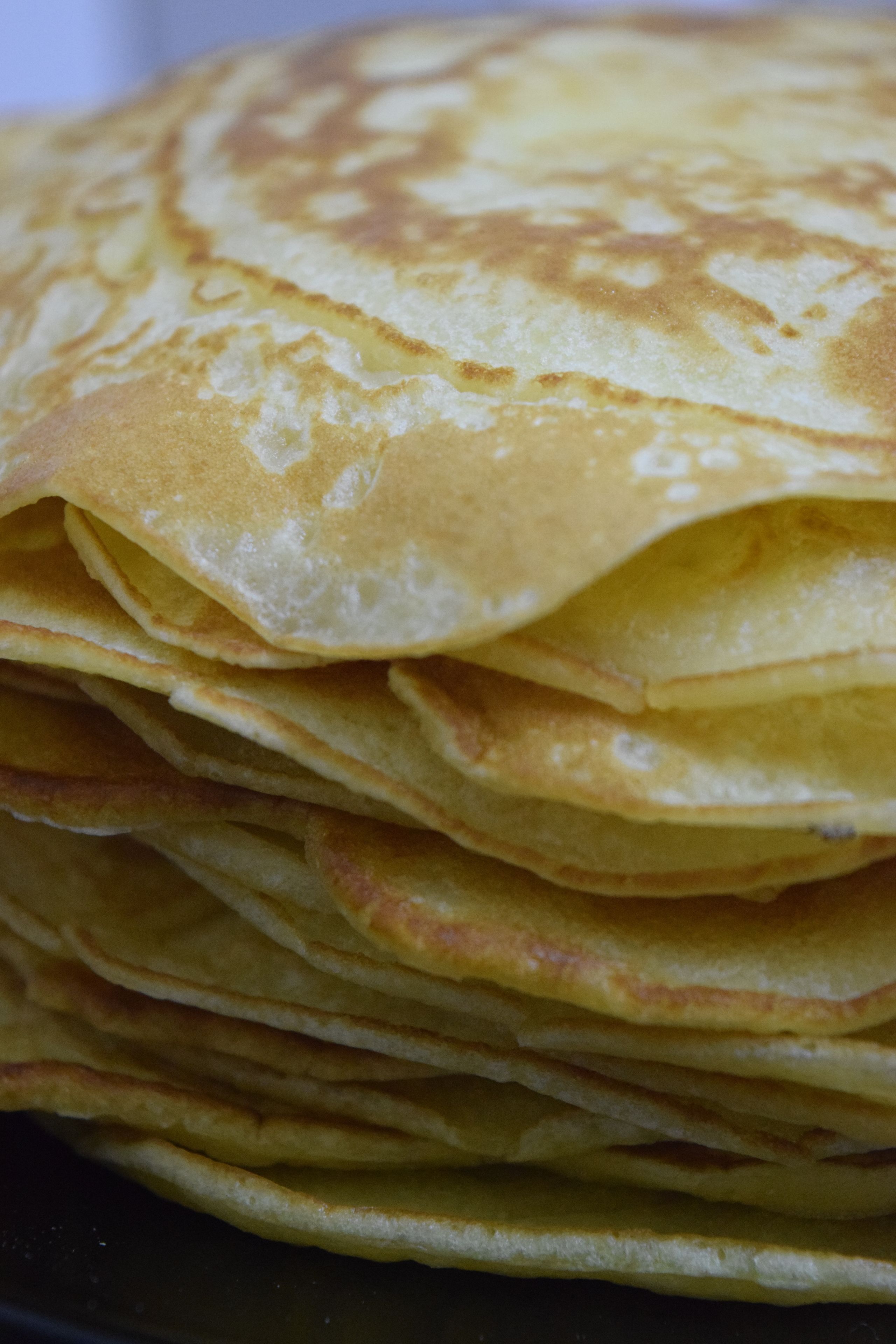 A stack of golden-brown crepes.