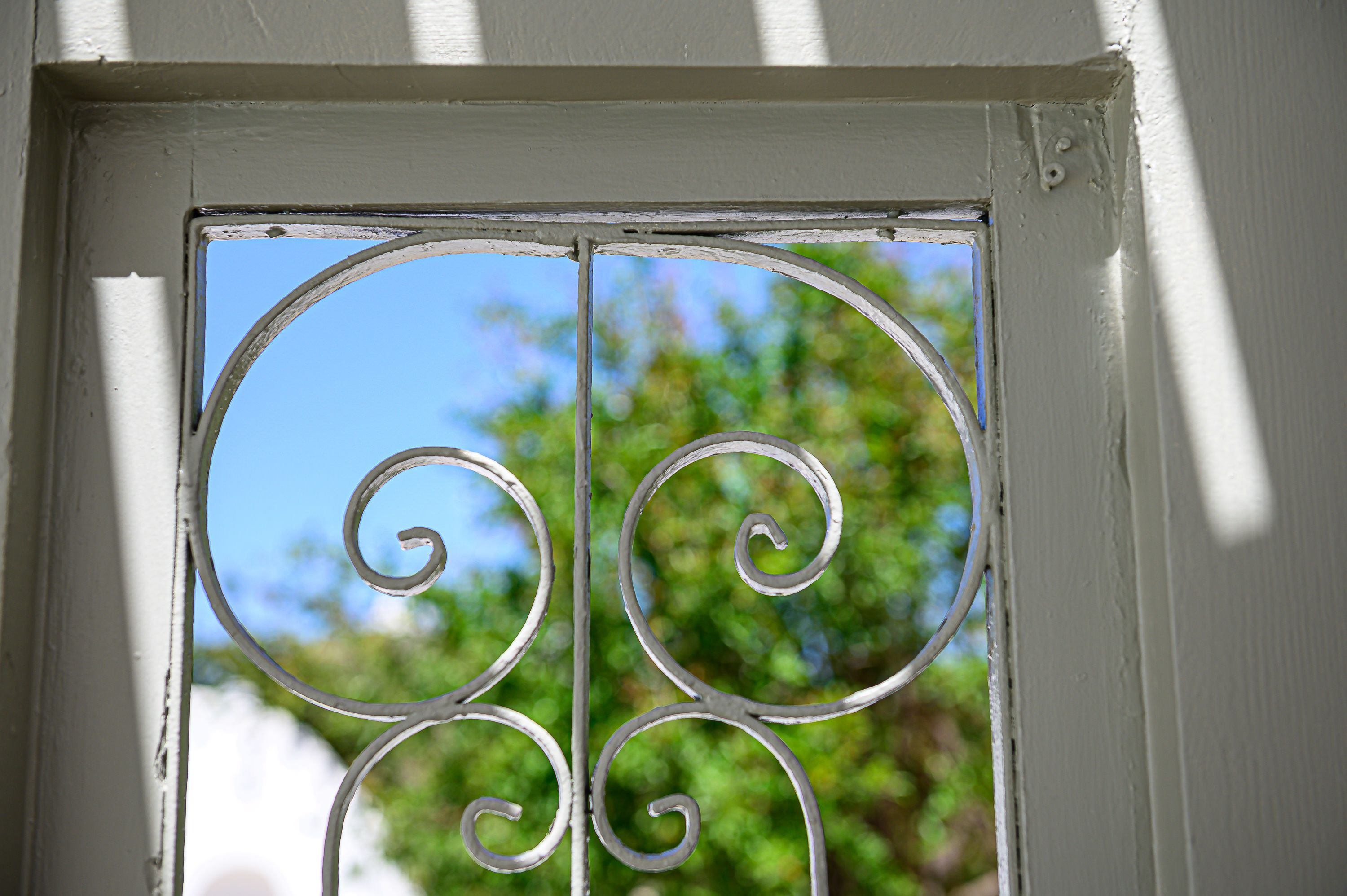 A window with a decorative metal grill.