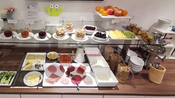 A buffet with various food items including fruits, cheeses, meats, and salads. - Schlafgut Domhof (Guntersblum)