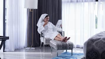 Relax in a serene space with a large window, comfortable seating, and a floor lamp.