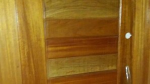 A wooden door with horizontal slats and a metallic handle. - New Mexico Hotel - Takoradi (Sekondi-Takoradi)