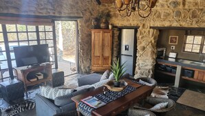 Luxury Cottage, Multiple Beds, Mountain View | Living area | Fireplace - Dawsons Game and Trout Lodge (Barberton)