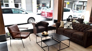 Una sala de estar moderna con un sillón de cuero, un sofá y una mesa de centro.
