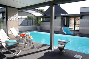 Indoor pool, open 9:00 AM to 9:00 PM, pool umbrellas, pool loungers