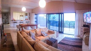 Executive Suite, 2 Bedrooms, Non Smoking, Sea View (Topaz) | Living area | 52-inch plasma TV with cable channels, TV