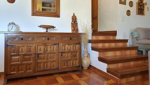 A wooden cabinet with multiple drawers, a mirror, and a vase with dried plants. - Apartment (full rental) San Nicolas for 5 people (Cuenca)