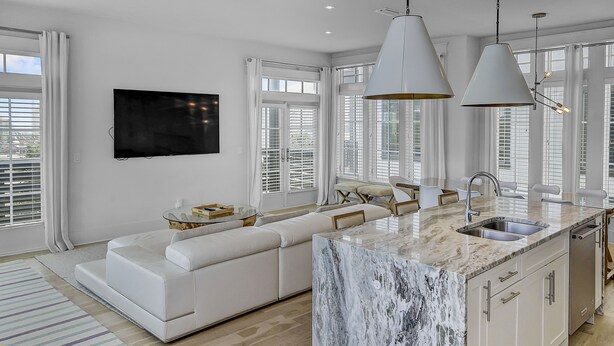 A modern kitchen with a marble island, white cabinetry, and pendant lighting. - Private pool. gulf views, great large Seagrove beach home (Santa Rosa Beach)