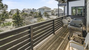 A balcony with a grill, chairs, and a view of houses. - Private pool. gulf views, great large Seagrove beach home (Santa Rosa Beach)