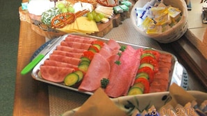 A buffet table with various food items including meats, cheeses, fruits, and vegetables. - Hotel Zur Kupferkanne (Kobern-Gondorf)