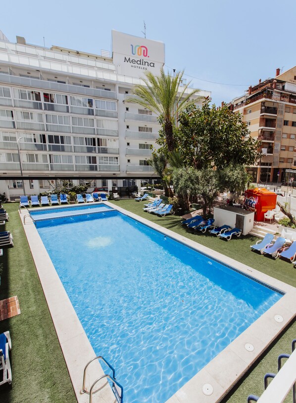 Outdoor pool, open 10:00 AM to 8:00 PM, pool umbrellas, pool loungers