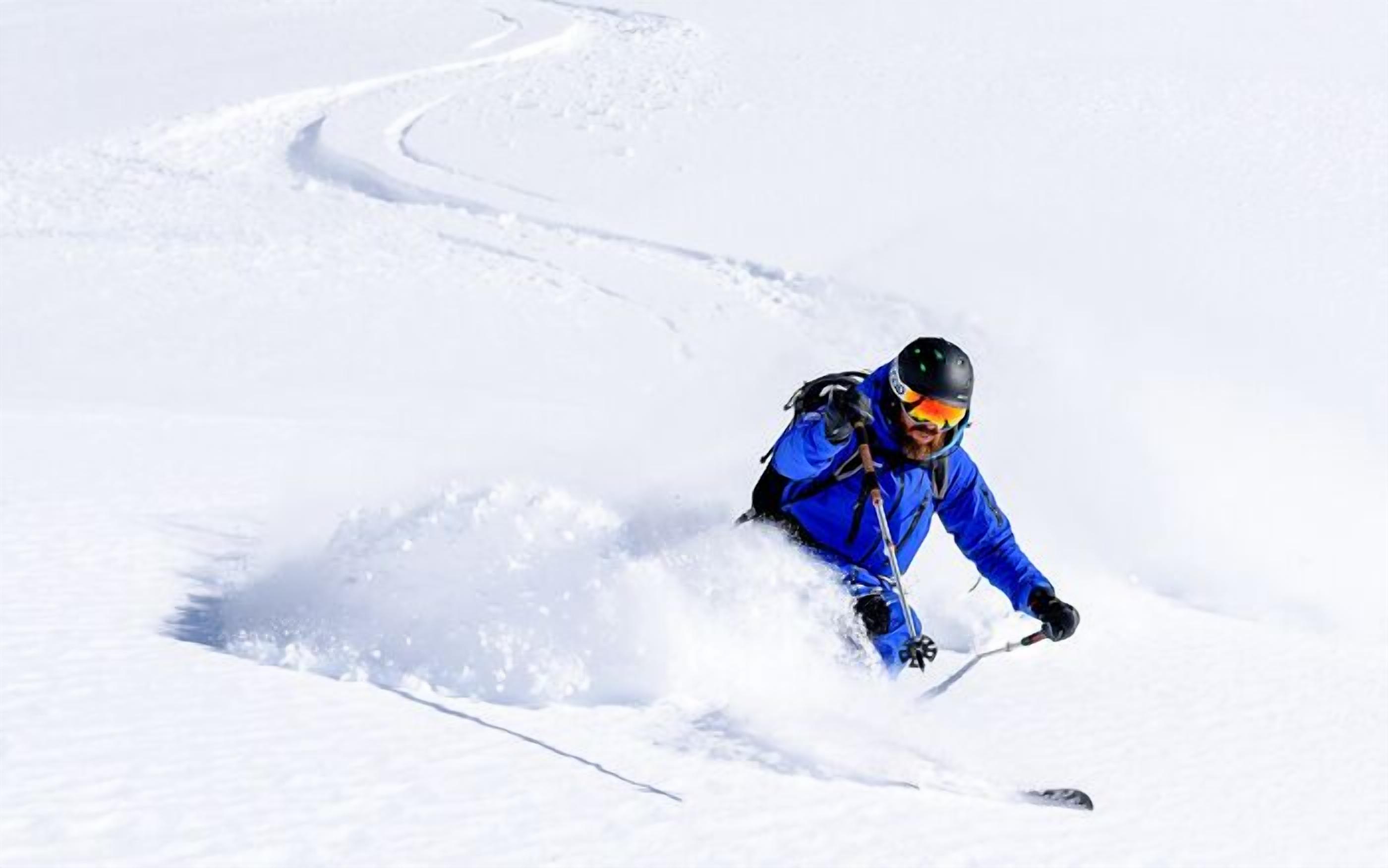 A person skiing down a snowy slope.