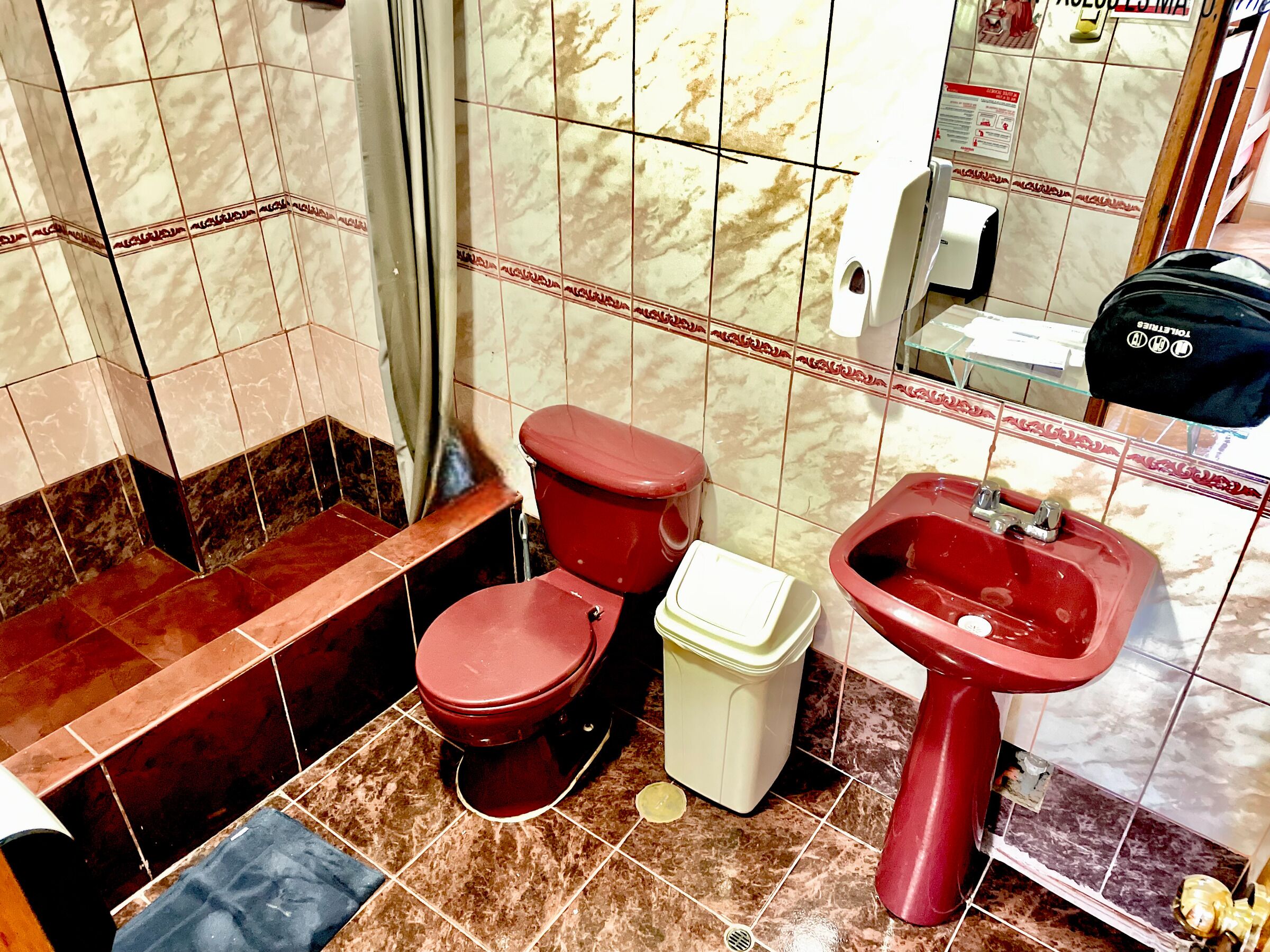 A bathroom with a toilet, bidet, and sink.