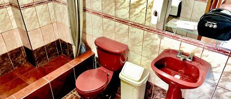 A bathroom with a toilet, bidet, and sink.