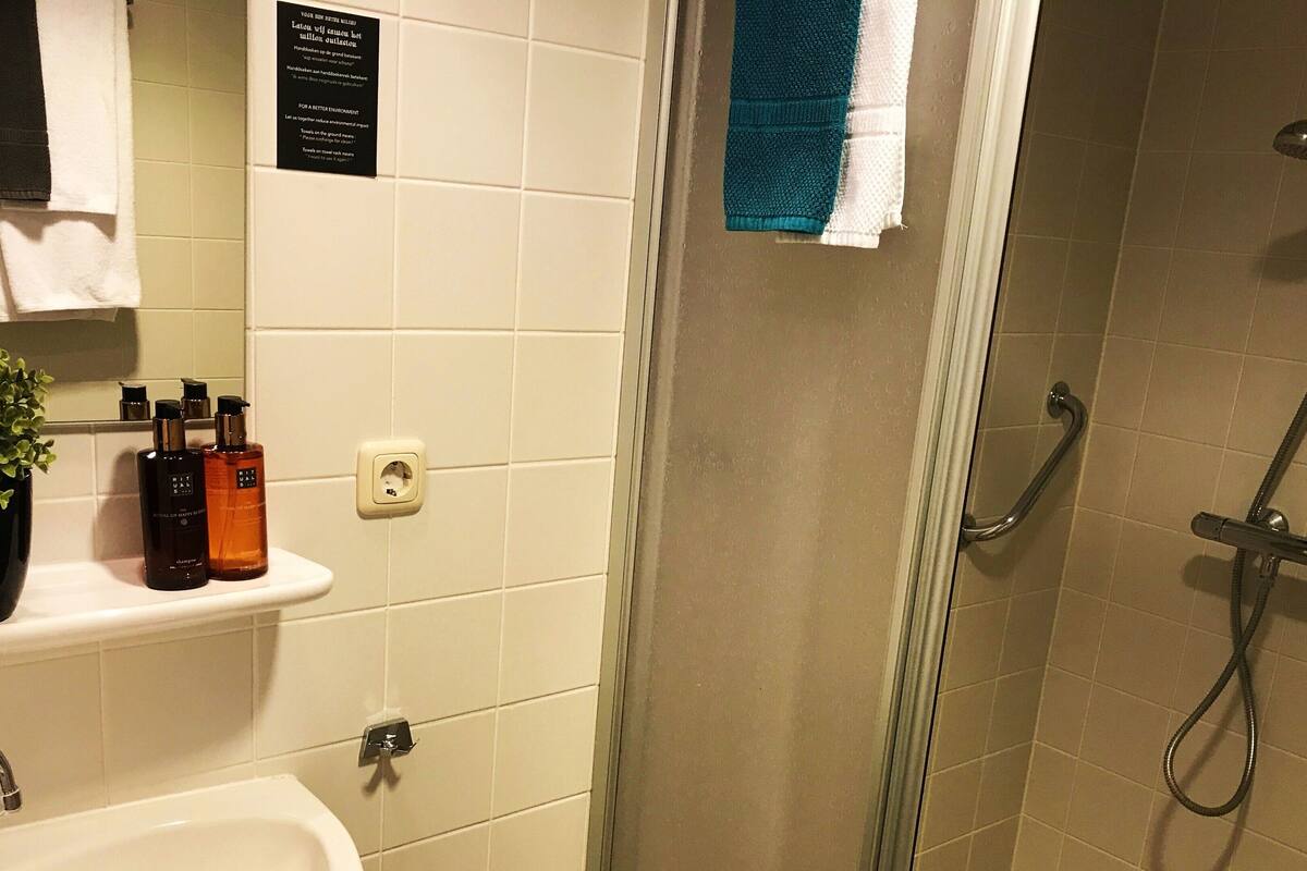 shower, designer toiletries, hair dryer, towels