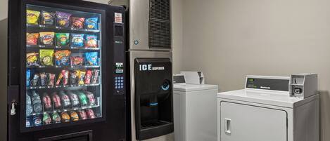 A vending machine with snacks and drinks, an ice dispenser, and a washing machine.