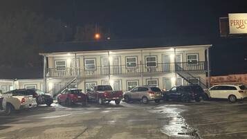A multi-story building with a parking lot.
