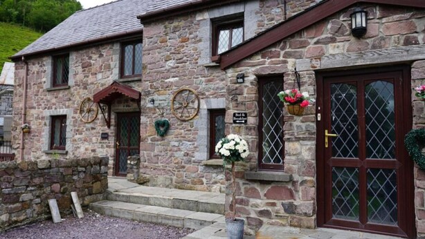 A stone building with a sign reading "Bed & Breakfast." - Pentre Riding Stable and Accommodation (Swansea)